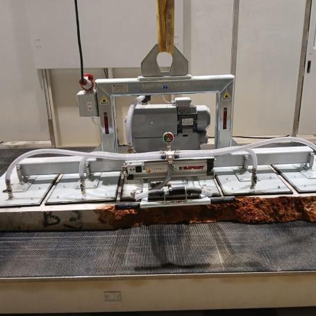 Manutention de tranche de pierre au pont roulant avec palonnier à ventouses